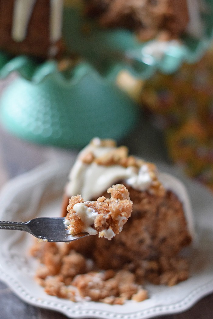 Apple Bundt Cake is a scrumptious fall dessert recipe that’s irresistible, made with apples, cinnamon, walnuts, and a caramel cream cheese glaze that runs down over the sides.