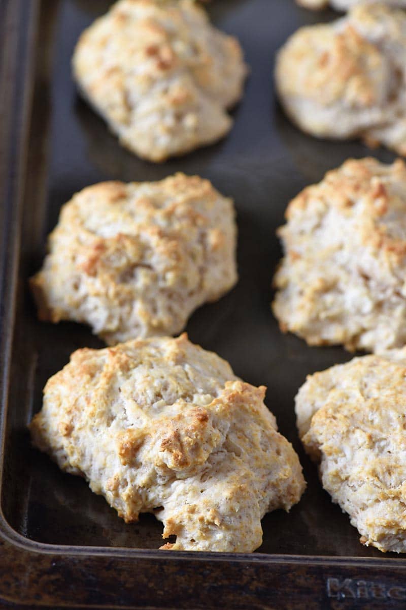 baked cinnamon biscuits, golden brown, on a baking sheet