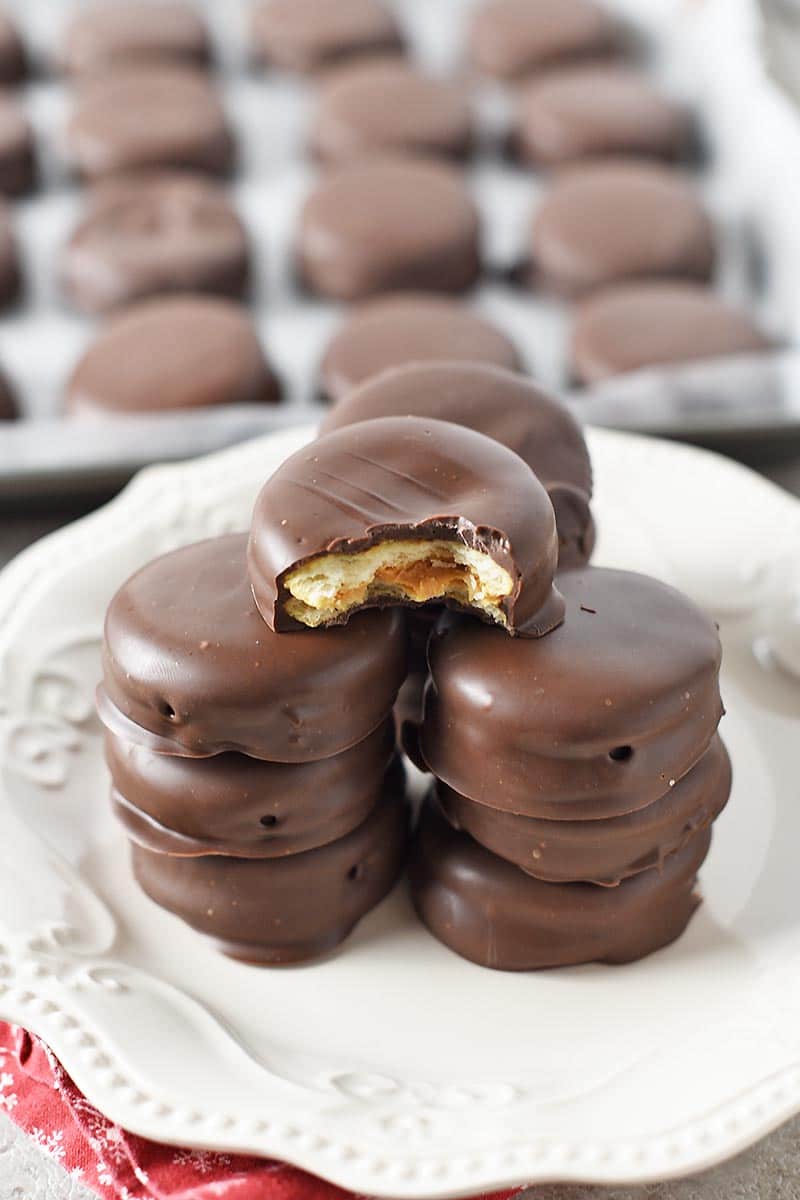 bite out of chocolate peanut butter Ritz crackers, stacked on white plate