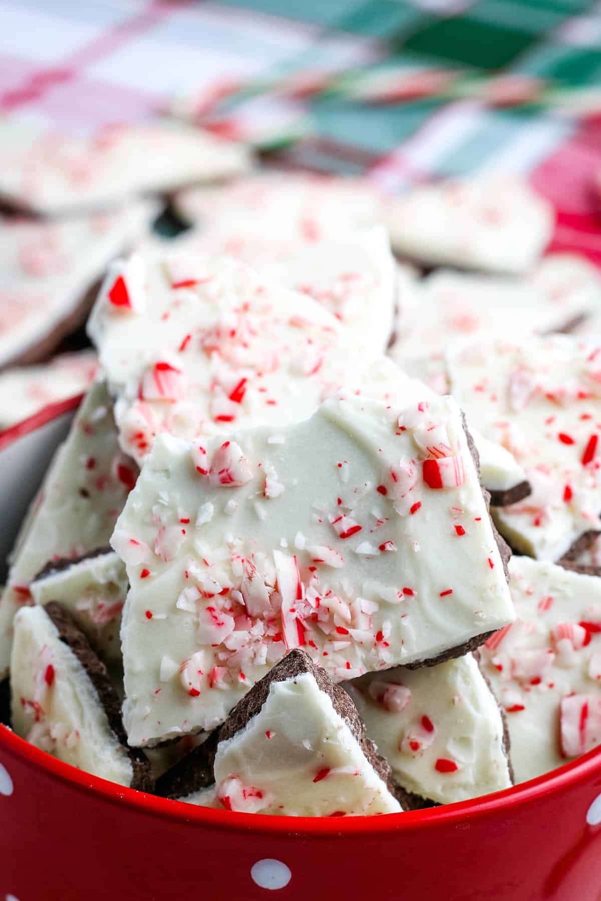 pile of chocolate candy cane bark in red bowl