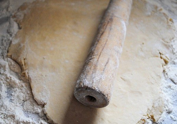 rolling pin on sugar cookie dough on floured surface