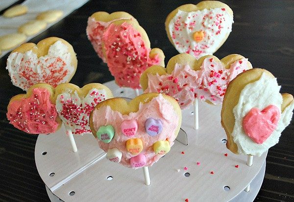heart shaped cookie pops in white cake pop stand