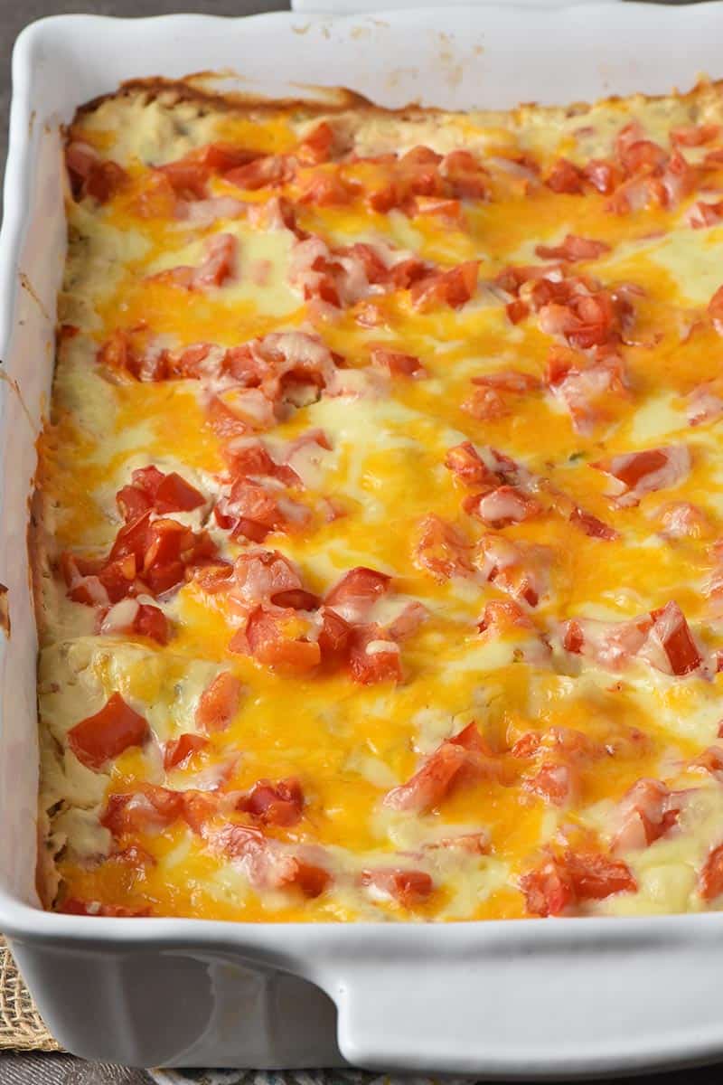baked chicken enchiladas in white baking dish