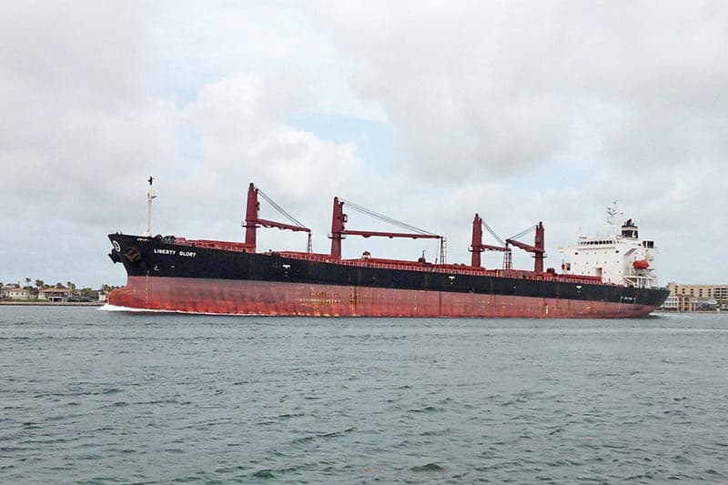 Liberty Glory ship sailing past San Jose Island in Port Aransas harbor on Texas coast
