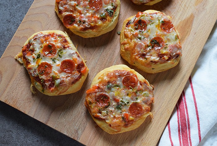Grands Mini Supreme Pizzas are a quick and easy dinner or lunch recipe with Grands Biscuits, pizza sauce, veggies, cheese, and pepperoni.