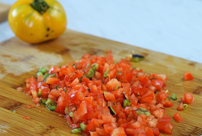 Grands Mini Supreme Pizzas are a quick and easy dinner recipe with Grands Biscuits, pizza sauce, freshly chopped peppers and tomato, cheese, and pepperoni.