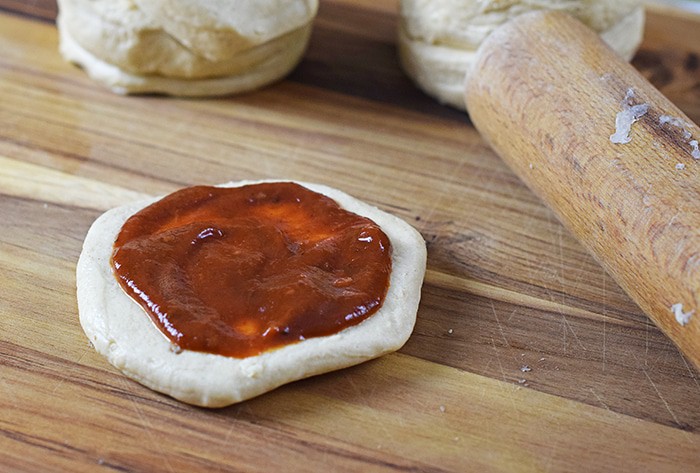 Grands Mini Supreme Pizzas are a quick and easy dinner recipe with Grands Biscuits rolled and flattened, then topped with pizza sauce, veggies, cheese, and pepperoni.