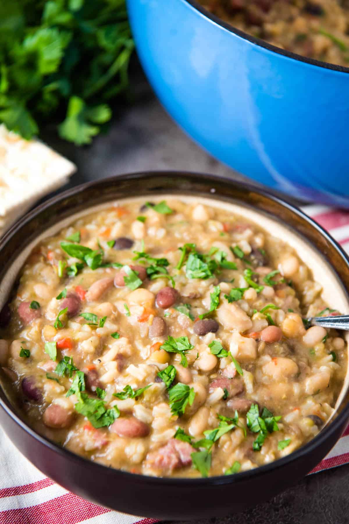 ham and 15 bean soup in brown soup bowl on red and white striped kitchen towel