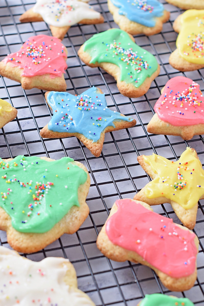 decorated Christmas cut out cookies on black wire rack