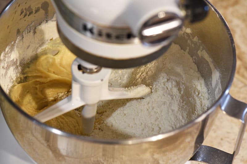 mixing dry ingredients with creamed mixture, making Christmas cookies, reindeer thumbprints