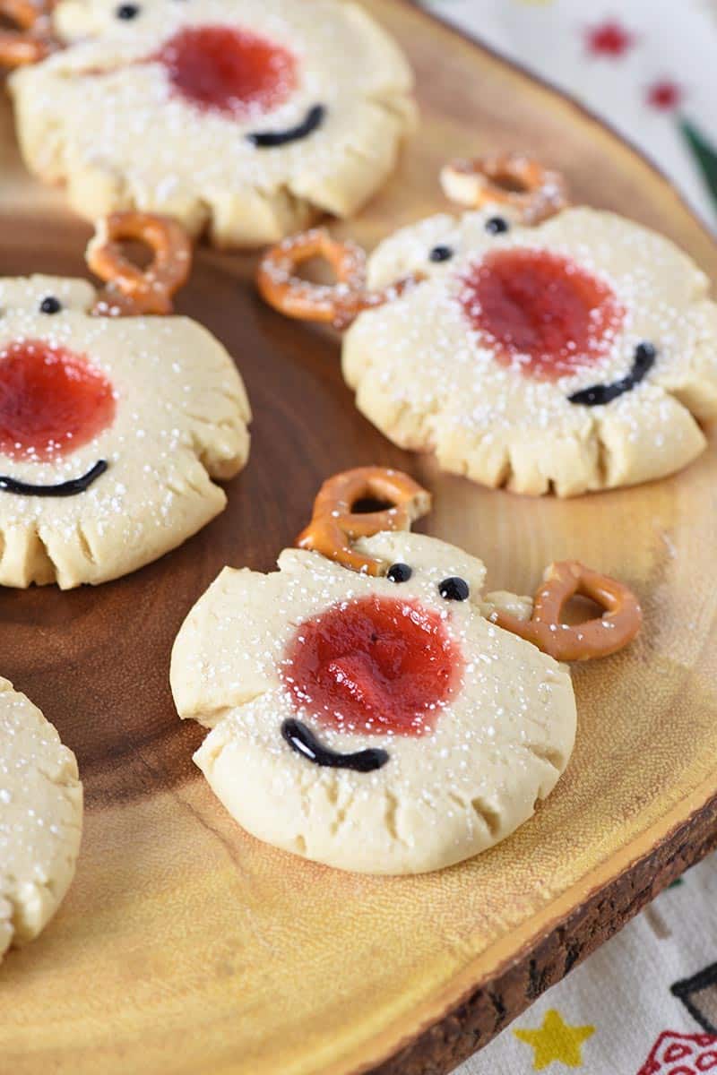 reindeer thumbprint cookies on log platter with Christmas kitchen towel