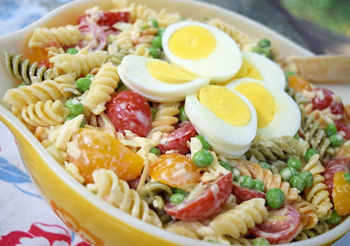 Rotini pasta coated with a lightly creamy dressing, mixed with fresh cucumbers, tomatoes, smoked cheese, and other delicious ingredients. Easy 30 minute pasta salad recipe!