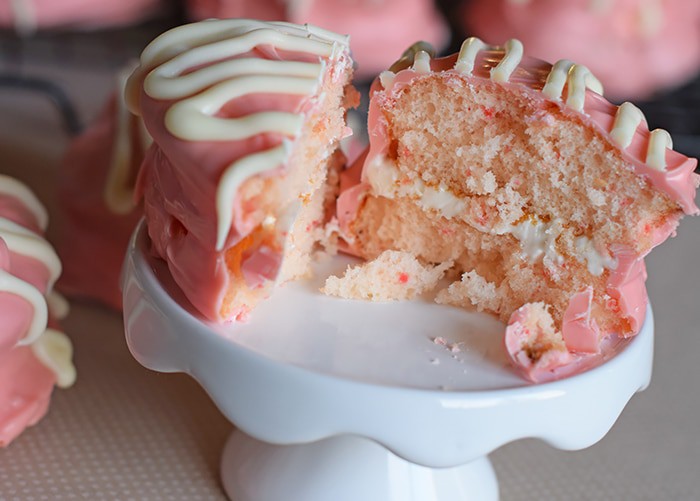 heart snack cakes sliced in half on white cupcake stand