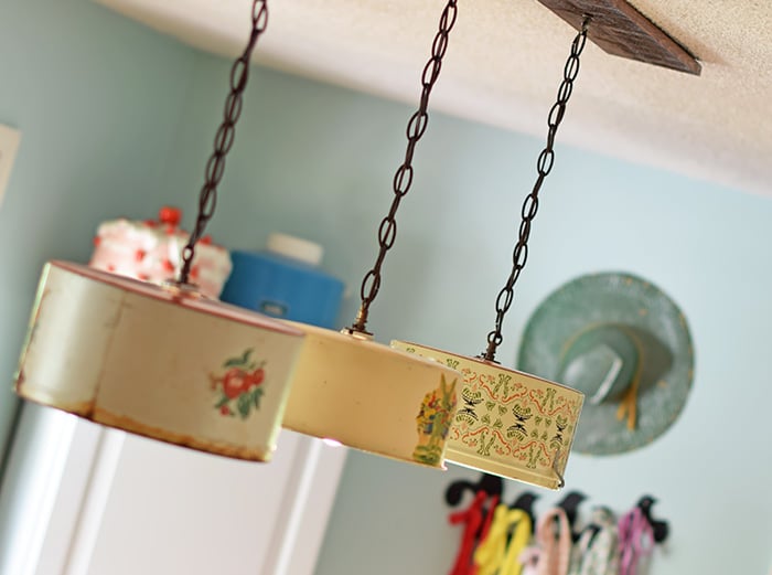 Create a farmhouse kitchen look with DIY light fixtures upcycled from vintage cake tins. How to create a charming look with affordable and simple kitchen lighting.