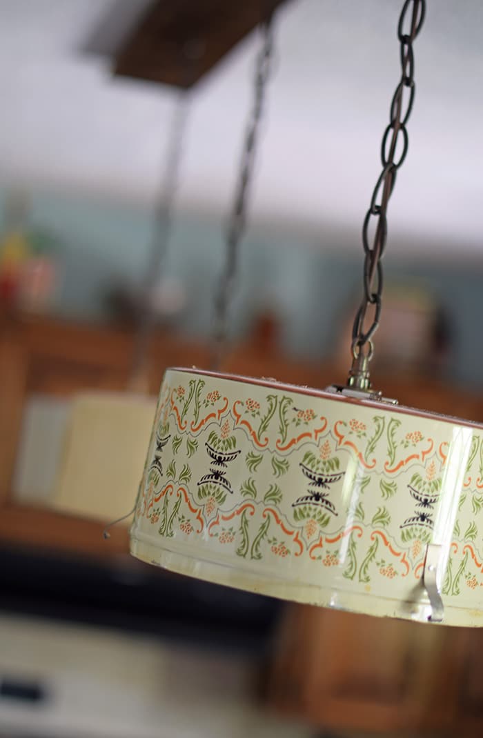 Create a farmhouse kitchen look with DIY light fixtures upcycled from vintage cake tins. How to create a charming look with affordable and simple kitchen lighting.