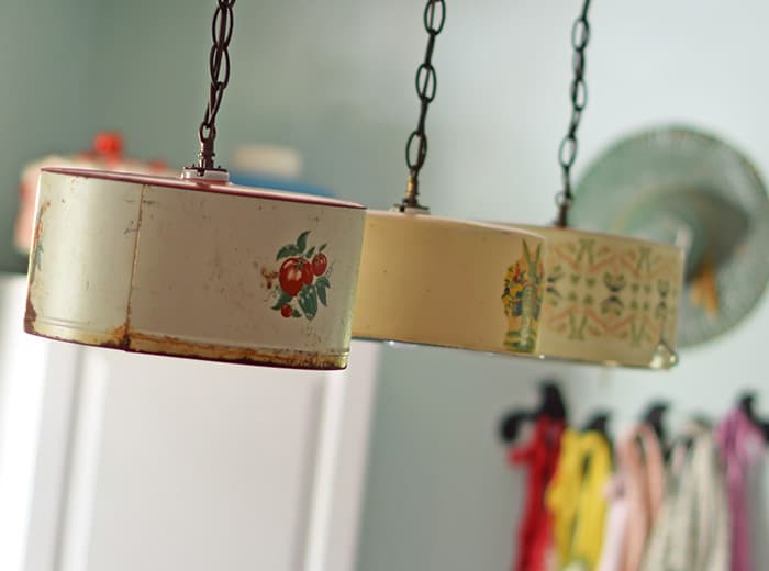 Create a farmhouse kitchen look with DIY light fixtures upcycled from vintage cake tins. How to create a charming look with affordable and simple kitchen lighting.