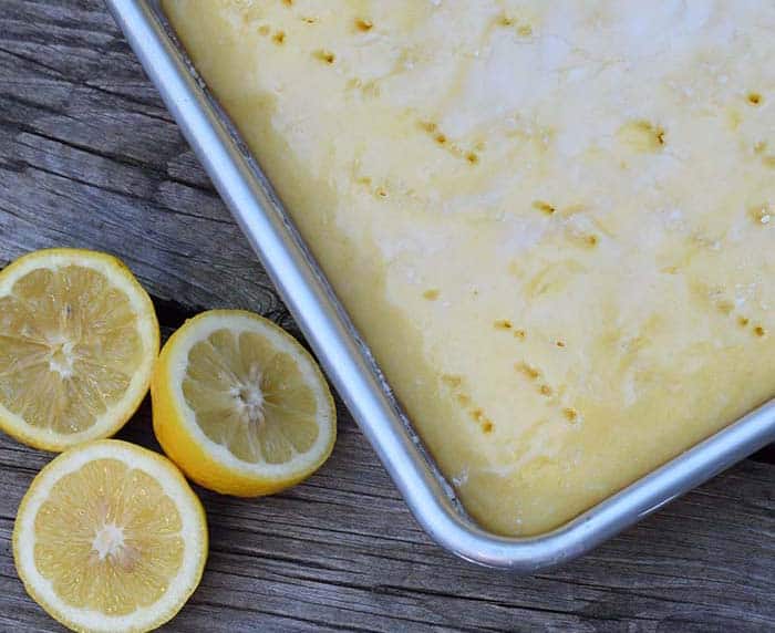 Grab the recipe for a lemon poke cake without any pudding mix. Cake mix recipe inspired by Grandma’s lemon cake. So scrumptious!