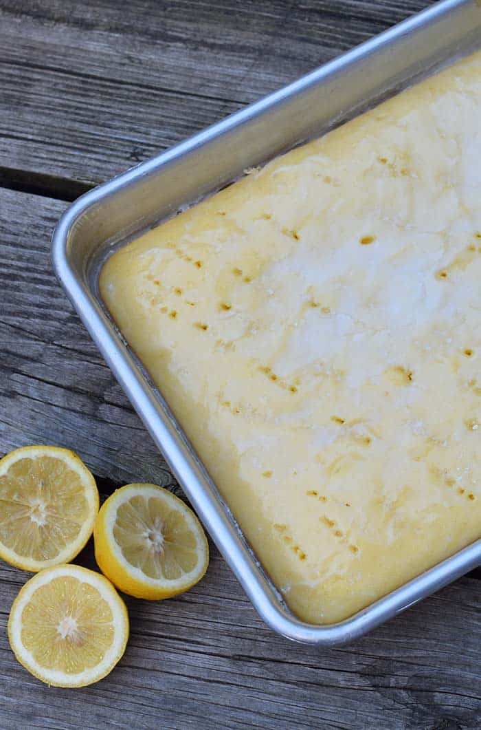 Grab the recipe for a lemon poke cake without any pudding mix. Cake mix recipe inspired by Grandma’s lemon cake. So scrumptious!