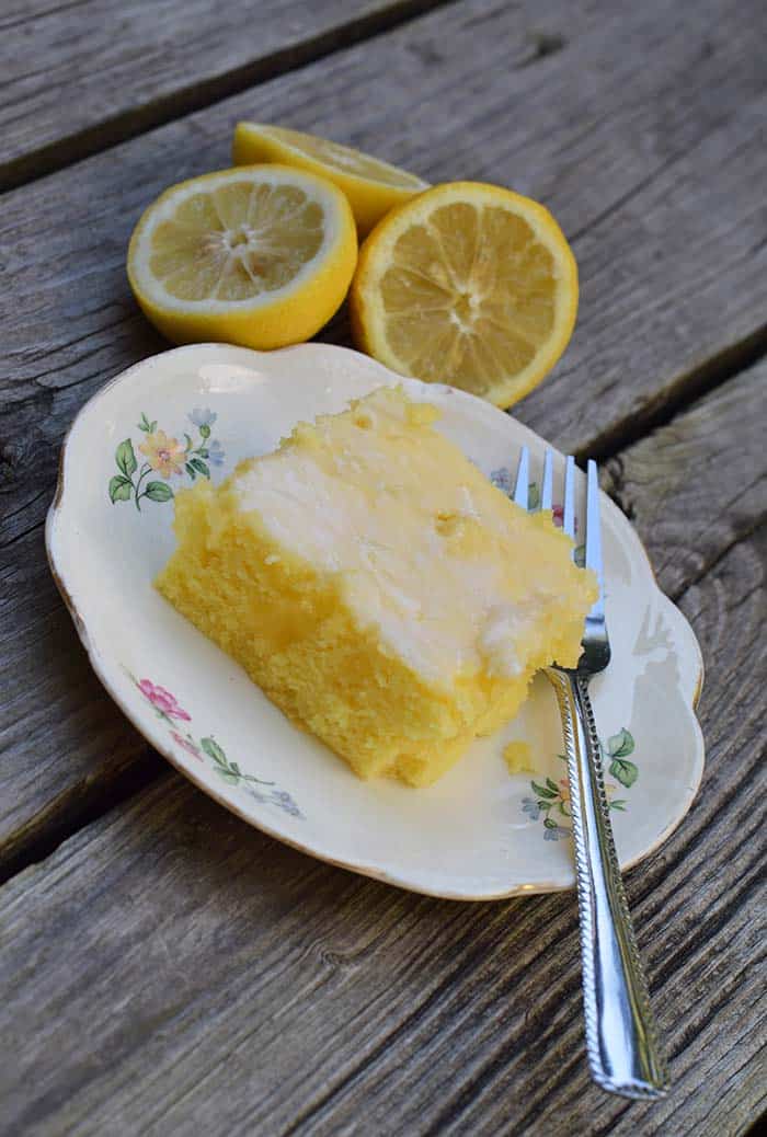 Grab the recipe for a lemon poke cake without any pudding mix. Cake mix recipe inspired by Grandma’s lemon cake. So scrumptious!