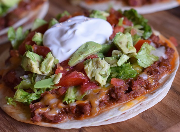 Homemade is way better, especially when it comes to Homemade Mexican Pizza with All the Fixin’s, like lettuce, tomatoes, and avocados. Enjoy a simple recipe that makes a delicious family meal and curbs those cravings for your favorite Mexican and Tex-Mex food.