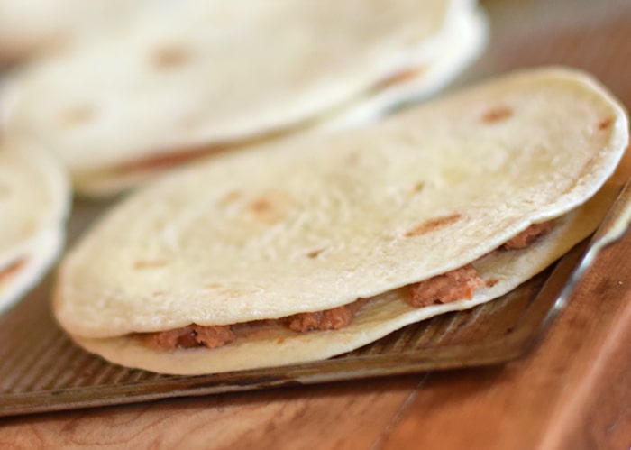 Homemade is way better, especially when it comes to Homemade Mexican Pizza with All the Fixin’s, like lettuce, tomatoes, and avocados. Enjoy a simple recipe that makes a delicious family meal and curbs those cravings for your favorite Mexican and Tex-Mex food.