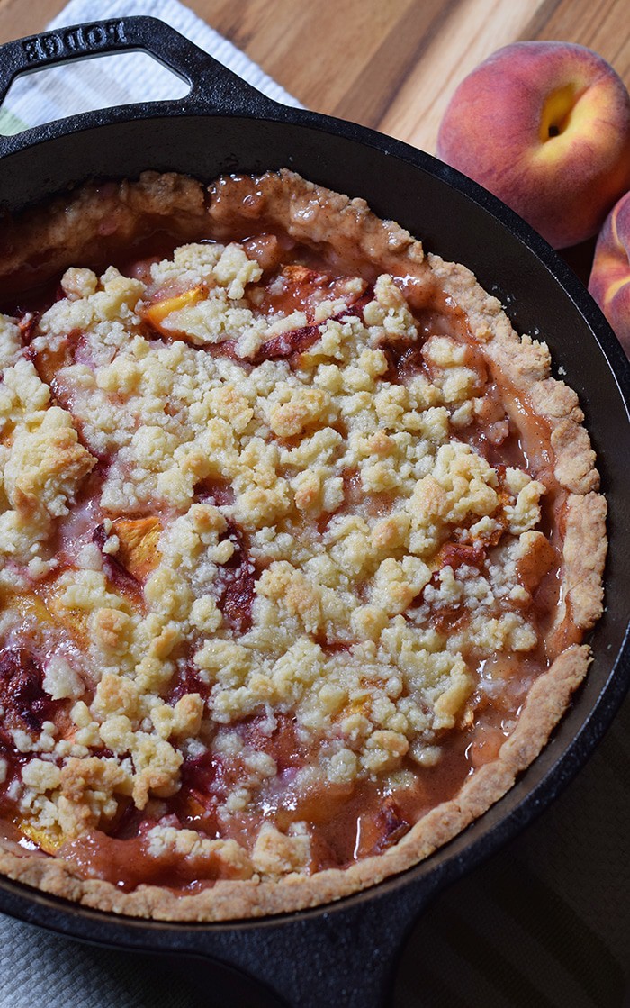 Peach cobbler is probably the easiest dessert recipe, besides chocolate chip cookies, you could ever make. Ingredients are simple, and the crust is a press-in crust, my favorite type of pie crust! Grab the recipe, bake it up in your favorite cast iron skillet (or baking dish), serve with vanilla ice cream, and watch it disappear.