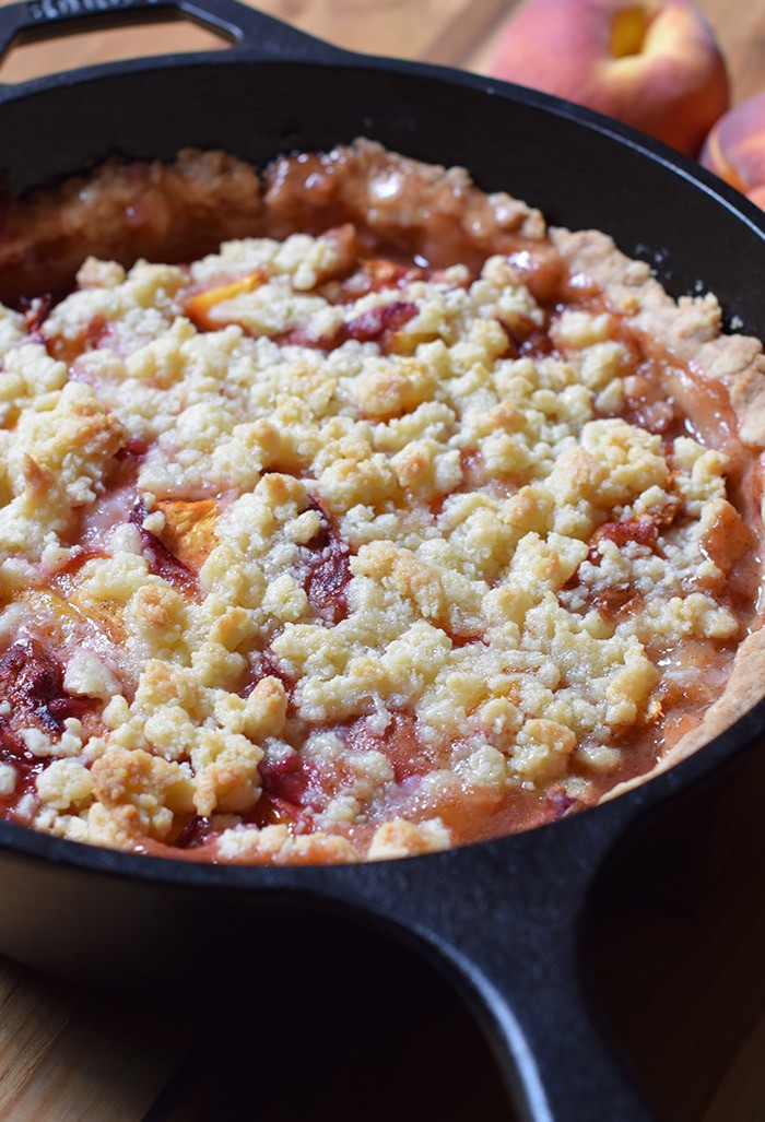 Peach cobbler is probably the easiest dessert recipe, besides chocolate chip cookies, you could ever make. Ingredients are simple, and the crust is a press-in crust, my favorite type of pie crust! Grab the recipe, bake it up in your favorite cast iron skillet (or baking dish), serve with vanilla ice cream, and watch it disappear.