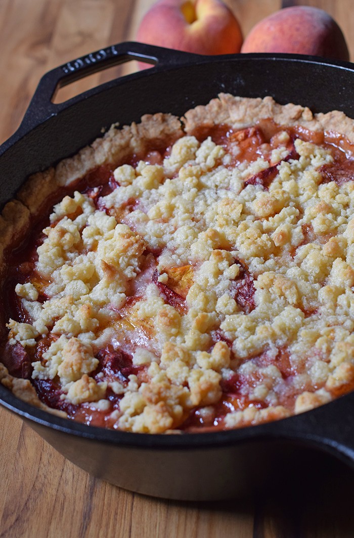 Peach cobbler is probably the easiest dessert recipe, besides chocolate chip cookies, you could ever make. Ingredients are simple, and the crust is a press-in crust, my favorite type of pie crust! Grab the recipe, bake it up in your favorite cast iron skillet (or baking dish), serve with vanilla ice cream, and watch it disappear.