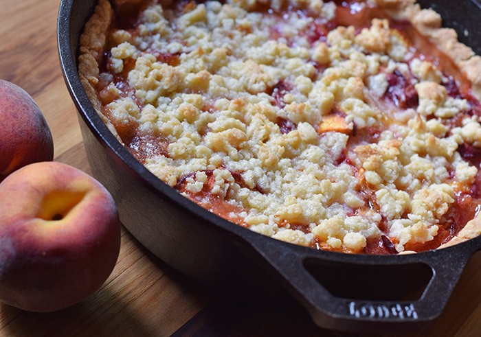 Peach cobbler is probably the easiest dessert recipe, besides chocolate chip cookies, you could ever make. Ingredients are simple, and the crust is a press-in crust, my favorite type of pie crust! Grab the recipe, bake it up in your favorite cast iron skillet (or baking dish), serve with vanilla ice cream, and watch it disappear.