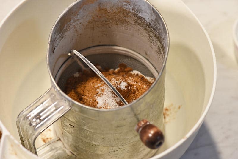 sifting dry ingredients for pumpkin roll recipe