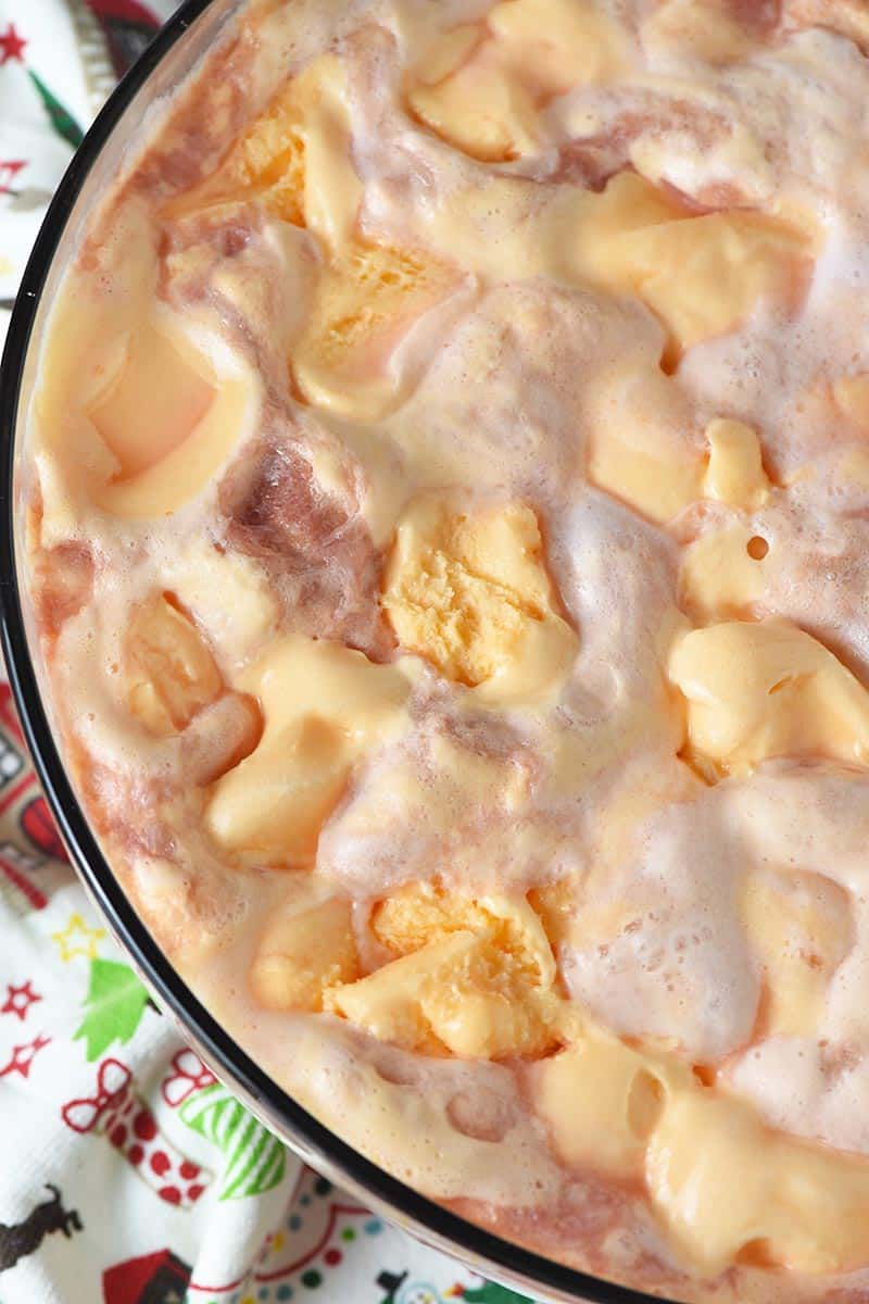 easy orange sherbet punch made in a large holiday punch bowl