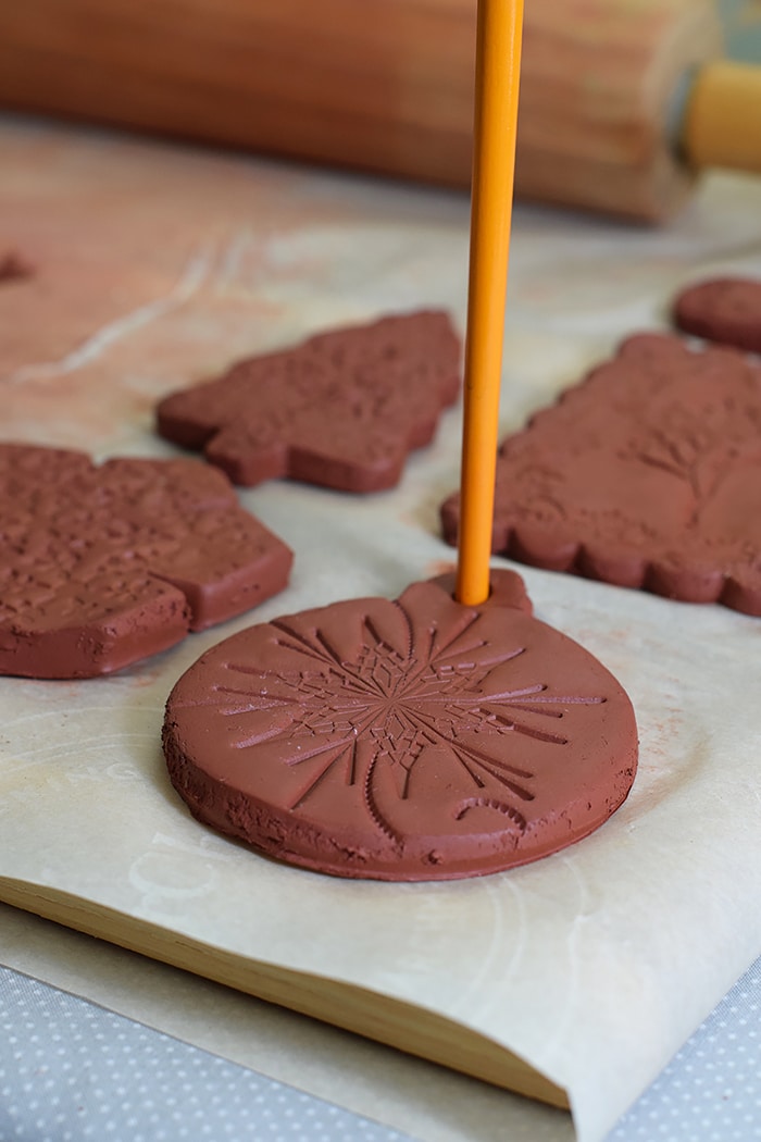 Use Air-Dry Clay, Christmas cookie cutters, and acrylic stamps to make the simplest of crafts, Clay Diffuser Ornaments. They're beautifully festive decorations for the Christmas season, and they add a touch of essential oil scents to both your tree and home.