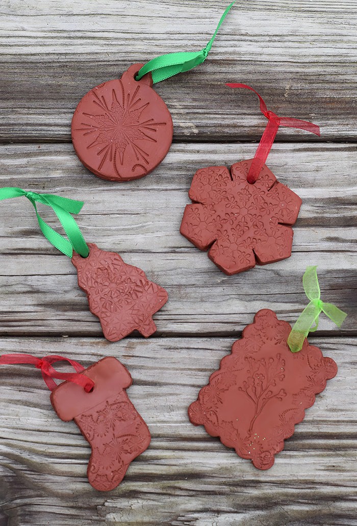 Use Air-Dry Clay, Christmas cookie cutters, and acrylic stamps to make the simplest of crafts, Clay Diffuser Ornaments. They're beautifully festive decorations for the Christmas season, and they add a touch of essential oil scents to both your tree and home.