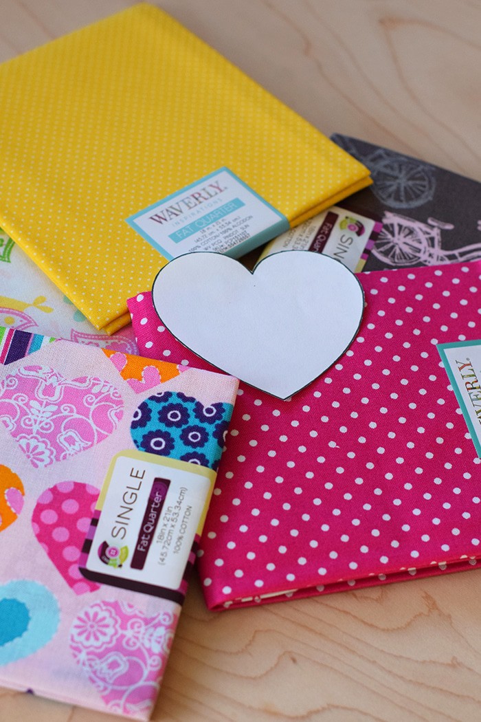 Decorate for Valentine's Day by making a super easy to sew Valentine's Day heart garland with cheap fat quarters from the fabric store. Makes the sweetest Valentine decoration and a fun craft and sewing project! 