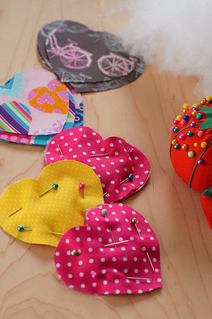 Decorate for Valentine's Day by making a super easy to sew Valentine's Day heart garland with cheap fat quarters from the fabric store. Makes the sweetest Valentine decoration and a fun craft and sewing project! 