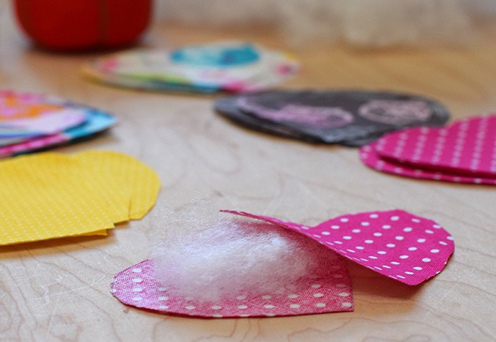 Decorate for Valentine's Day by making a super easy to sew Valentine's Day heart garland with cheap fat quarters from the fabric store. Makes the sweetest Valentine decoration and a fun craft and sewing project! 