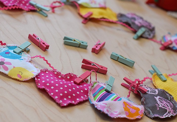 Decorate for Valentine's Day by making a super easy to sew Valentine's Day heart garland with cheap fat quarters from the fabric store. Makes the sweetest Valentine decoration and a fun craft and sewing project! 