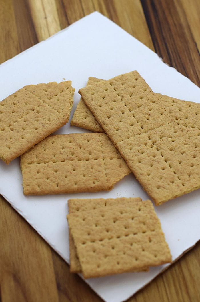Make a fun and edible kids craft this St. Patrick's Day, a Graham Cracker Leprechaun House. Gather rainbow colored candies, Decorating Icing, and graham crackers, and you're all set!