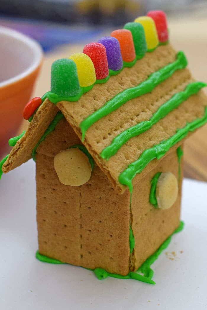 Make a fun and edible kids craft this St. Patrick's Day, a Graham Cracker Leprechaun House. Gather rainbow colored candies, Decorating Icing, and graham crackers, and you're all set!