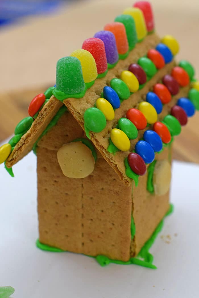 Make a fun and edible kids craft this St. Patrick's Day, a Graham Cracker Leprechaun House. Gather rainbow colored candies, Decorating Icing, and graham crackers, and you're all set!