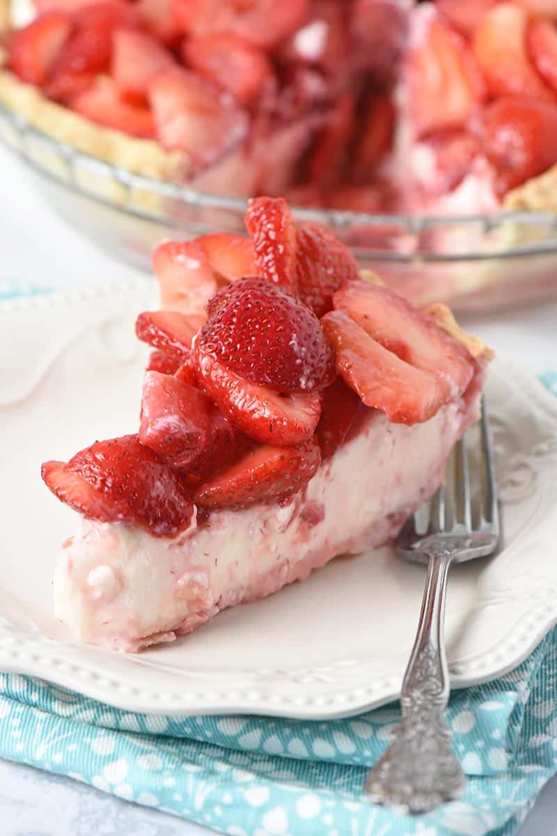 slice of strawberry cream cheese pie on white plate with fork