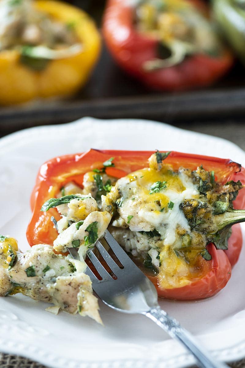 chicken stuffed bell pepper on white plate with fork