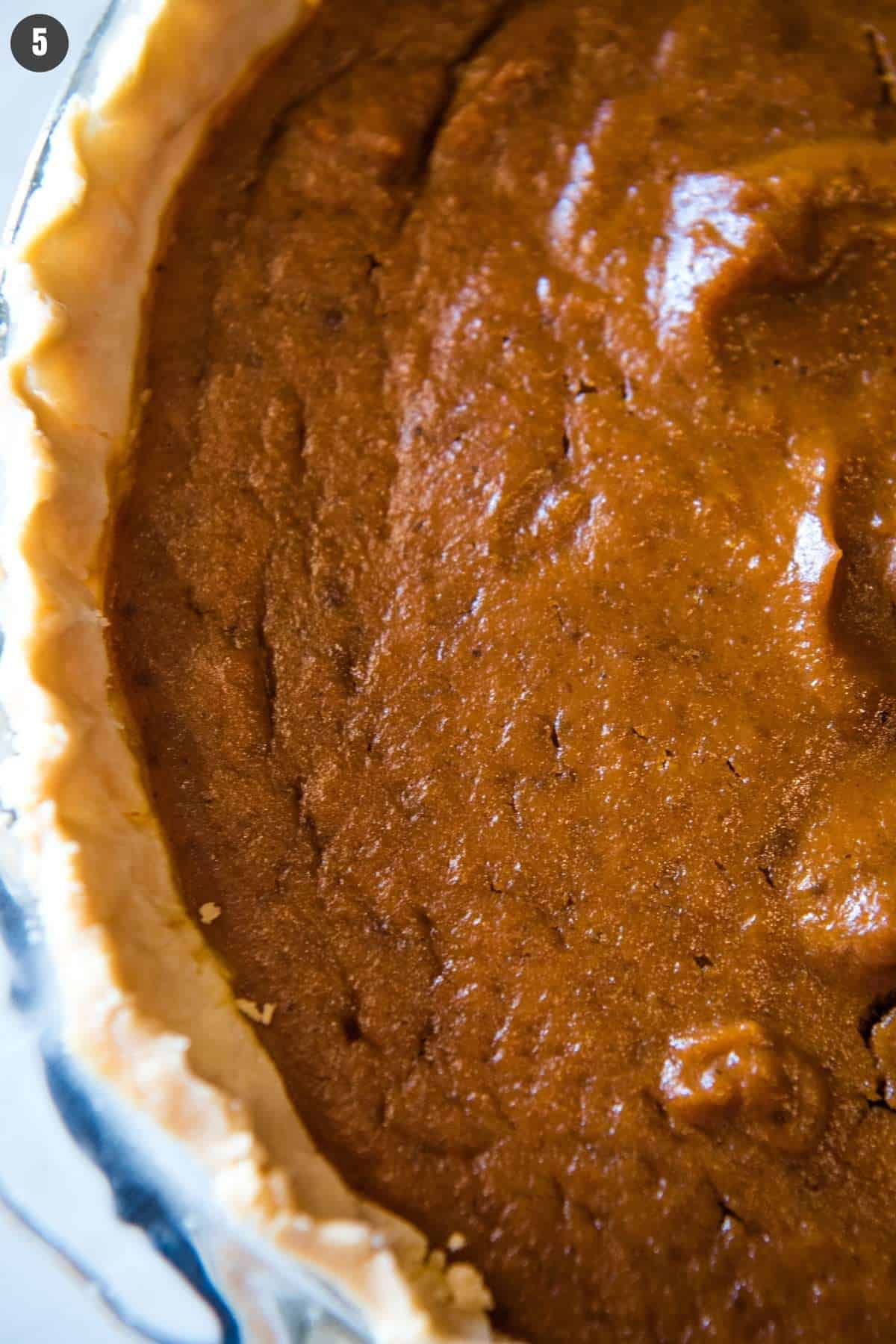 whole American pumpkin pie in pie plate