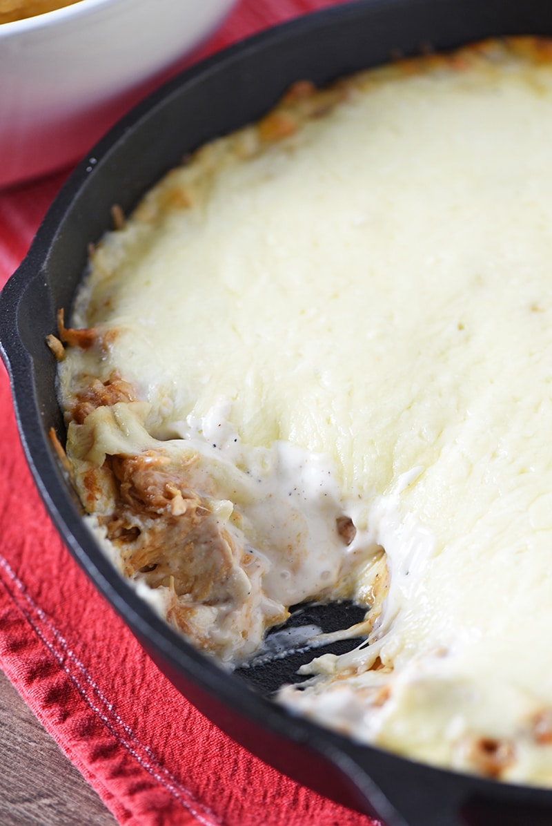 Easy appetizer and snack idea, Creamy BBQ Chicken Dip. Made with cream cheese, BBQ sauce, and Ranch dressing, it’s delicious with tortilla chips and raw vegetables.