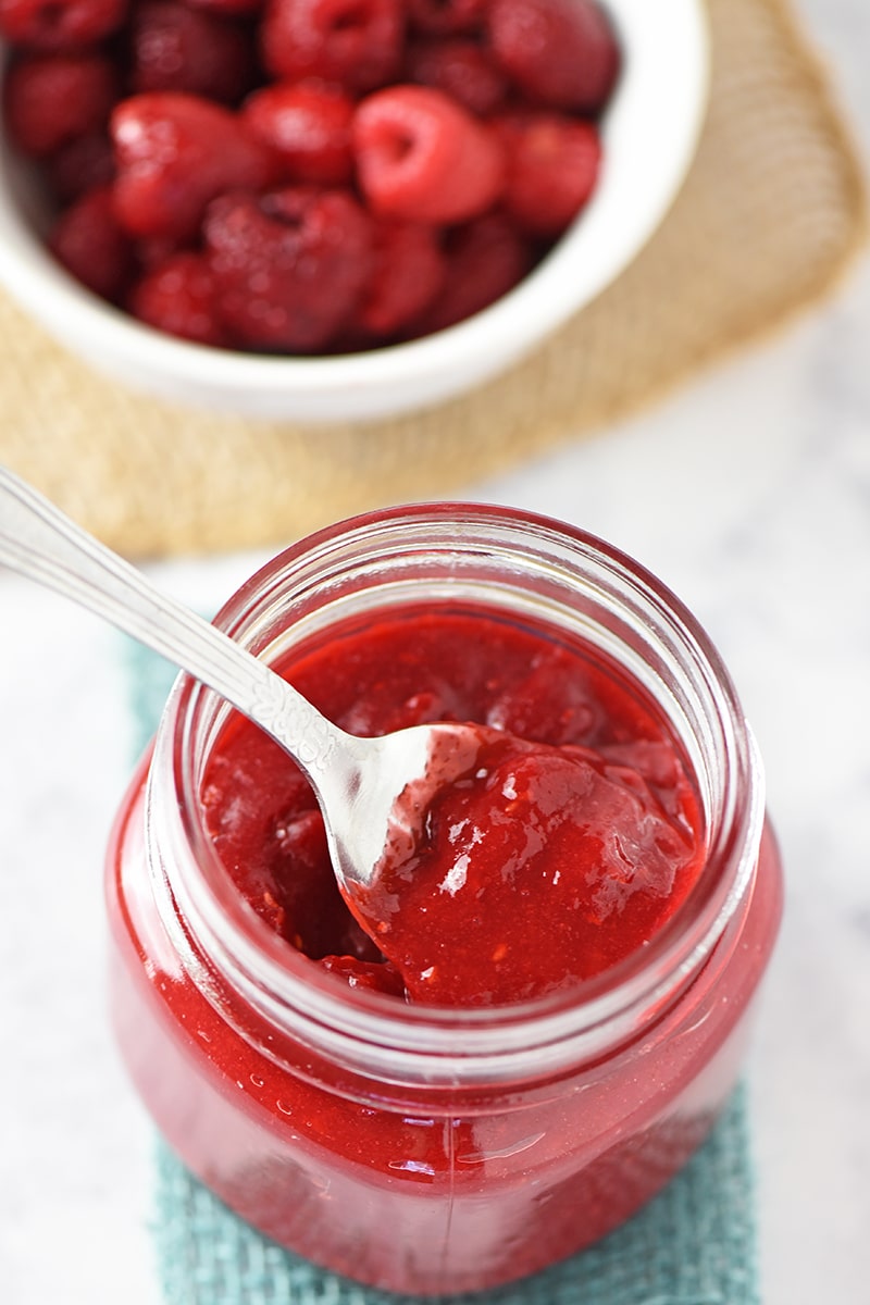 Spoonful of Homemade Raspberry Sauce in a Jar