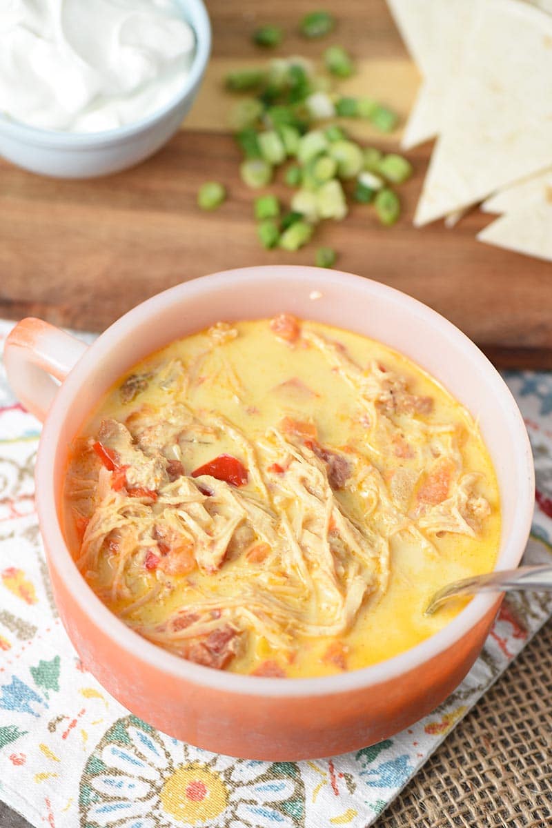 orange bowl of easy chicken tortilla soup with shredded chicken