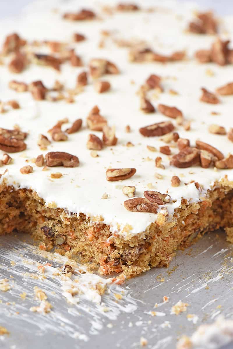 best cream cheese frosting on top of carrot cake in a sheet pan