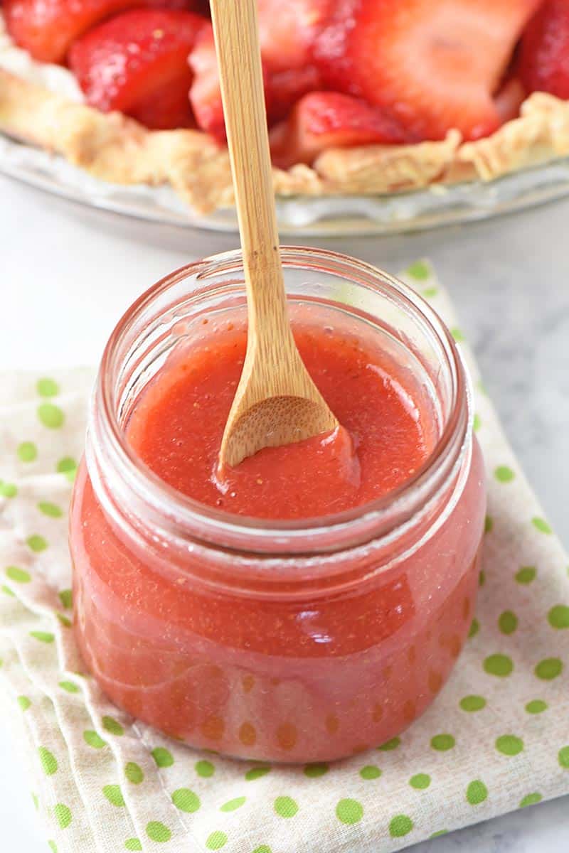 spoonful of homemade strawberry sauce in mason jar