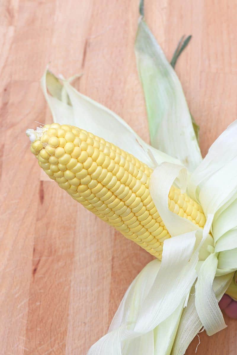 grilled corn on the cob with husks folded back and silks removed before grilling
