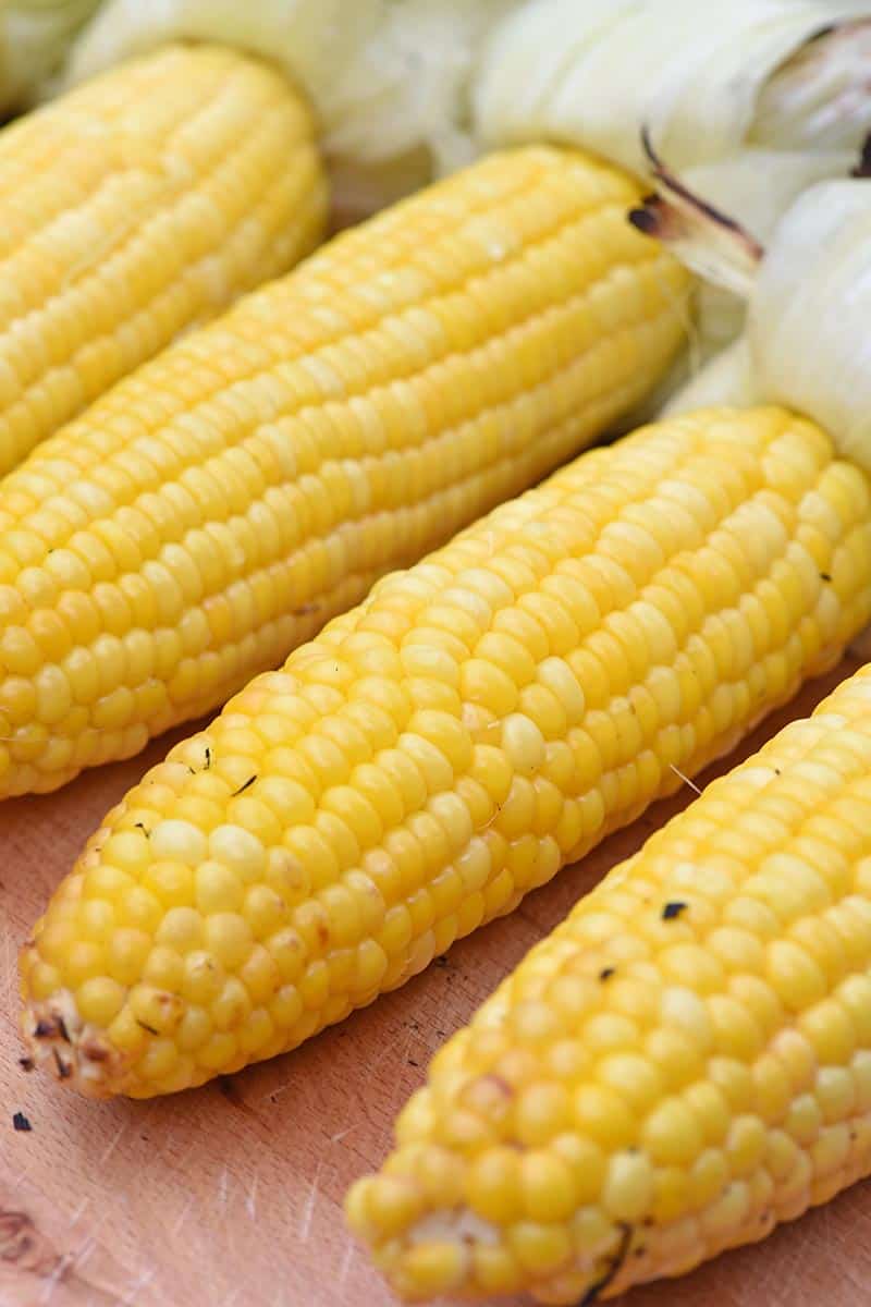 grilled sweet corn up close with husks pulled back